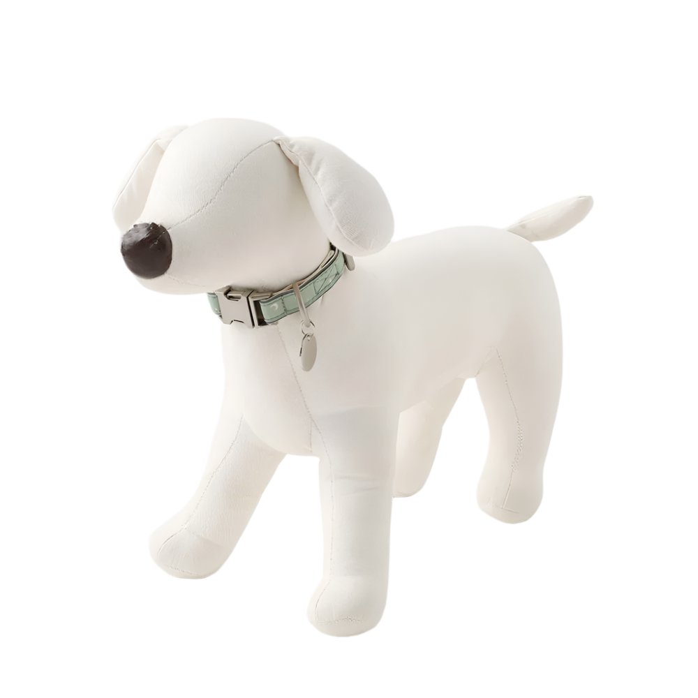 White dog mannequin display with a green collar on a light gray background