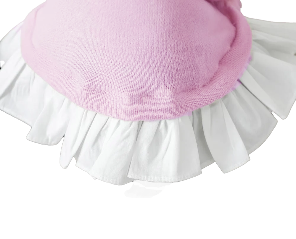 Close-up of a pink sweater with a white ruffled skirt on a white background