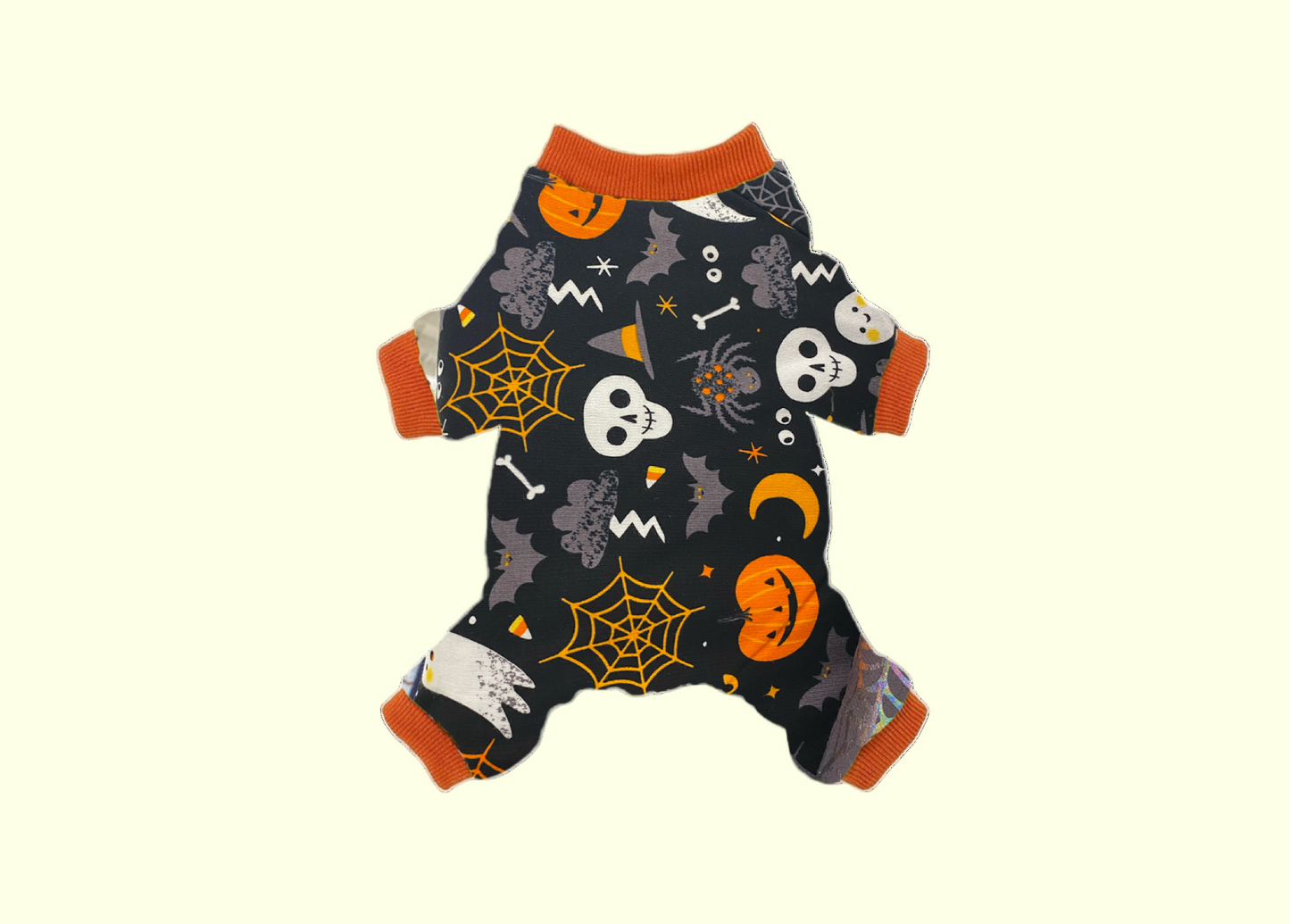 Pet onesie with Halloween-themed print including pumpkins, skulls, and spider webs