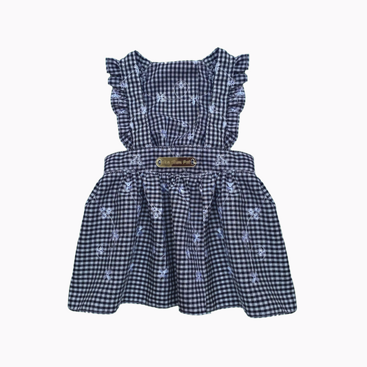 Black checkered dress with ruffled sleeves with embroidered floral on a white background