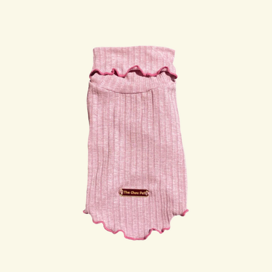 Pink pet dress with ruffled trim on a white background