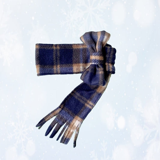 Plaid scarf with bow detail set on a snowy background