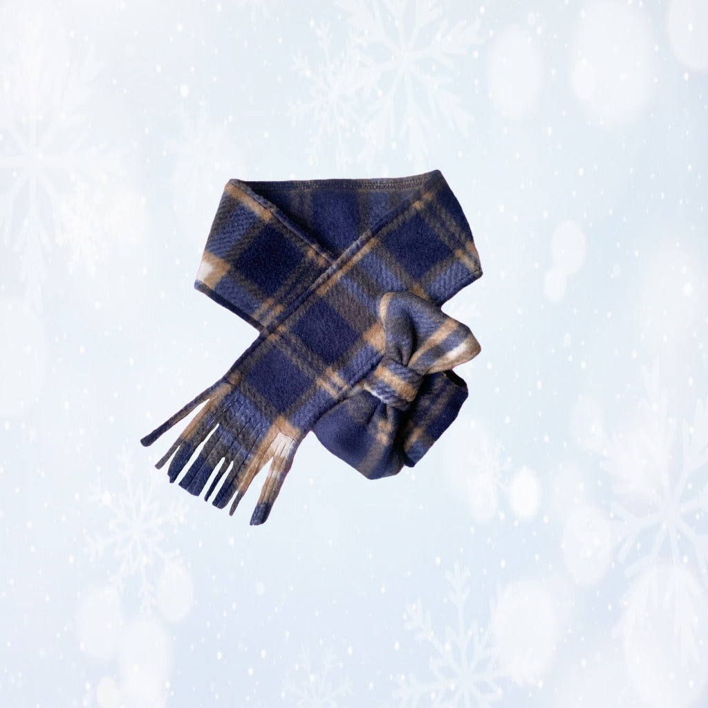 Plaid scarf with fringes on a light blue background